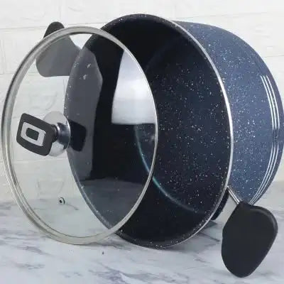Black speckled cookware set with glass lid on a marble surface