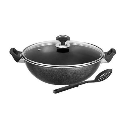 Black wok with glass lid and spatula on a white background